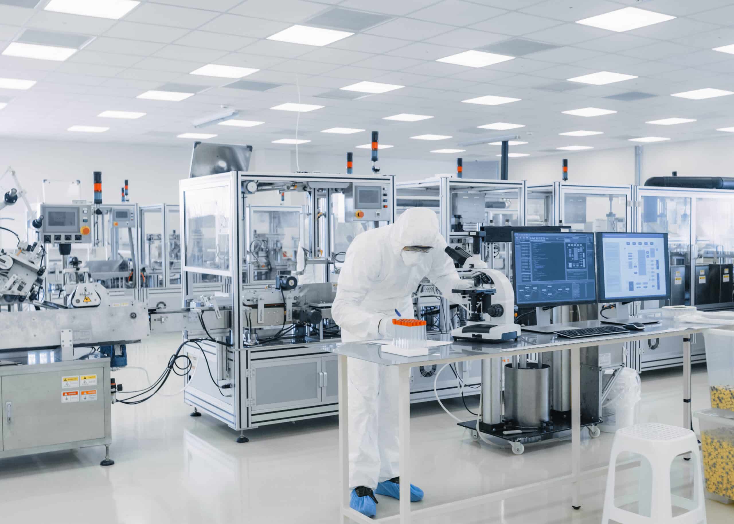 mes solutions, pharma mes, A lab worker in a manufacturer room writing down notes